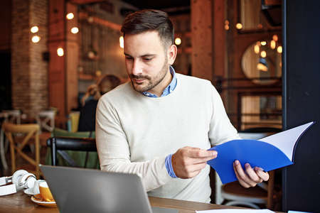 Man is enjoying coffee shop and doing his freelance job.の写真素材