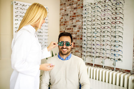 Man is checking eyesight in optics store.