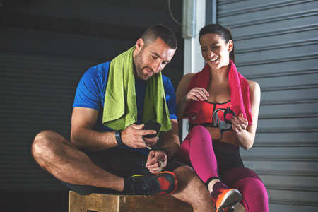 Young athlete couple is relaxing after training.の写真素材