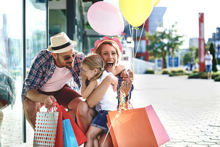 Happy family is enjoying shopping early in the morning.の写真素材