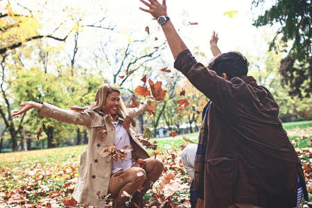 Young couple is enjoying fall in the park.の写真素材