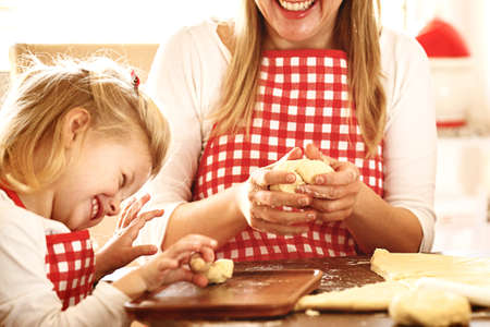 Happy family enjoying baking cakes early in the morning.の写真素材