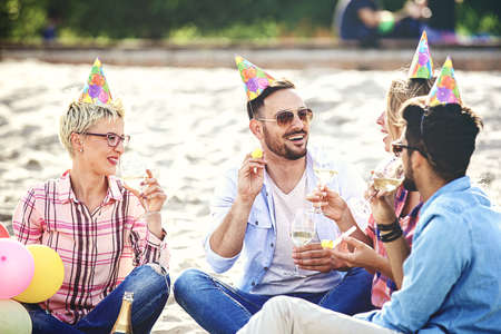 Friends enjoying birthday party on the beach.の写真素材