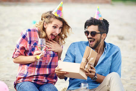 Friends enjoying birthday party on the beach.の写真素材