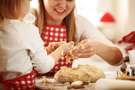 Happy family enjoying baking cakes early in the morning.の写真素材