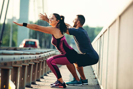Couple is exercise on the bridge early in the morning.の写真素材