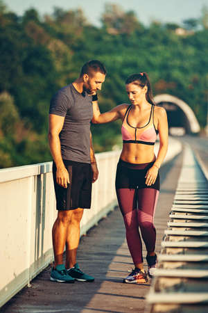 Couple is exercise on the bridge early in the morning.の写真素材