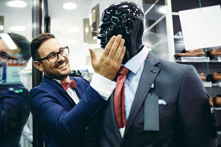 Handsome young man buying clothes in the store.の写真素材
