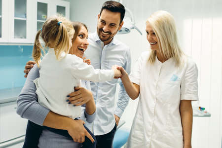 Female dentist and young girl patinet in dentist office.の写真素材