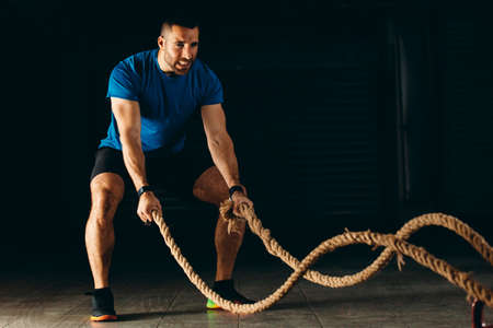 Man is training with rope in garage.の写真素材