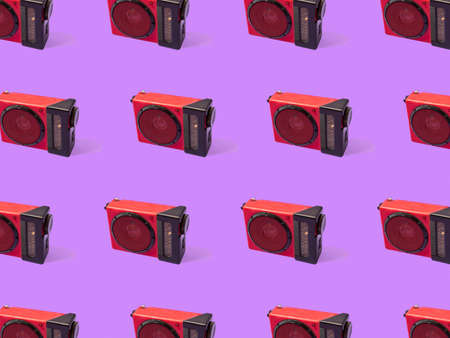 Trendy and cool purple pattern made of red radio player. Purple background. Minimal concept. Cool music idea.の写真素材