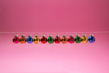 Christmas and New Year decorations, with shine objects. Pink background.