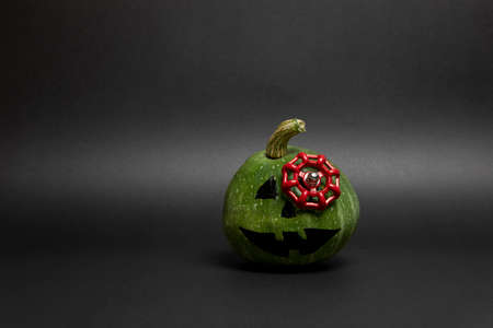 Green pumpkin with valve in it. Halloween decoration. Cool. Original photo. Black background.の写真素材