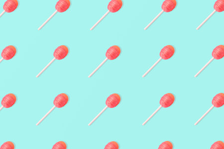 Trendy mint pattern made of pink lollipop. Pink background. Minimal concept. Sweets.