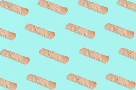 Sticking plasters pattern. Light blue background.