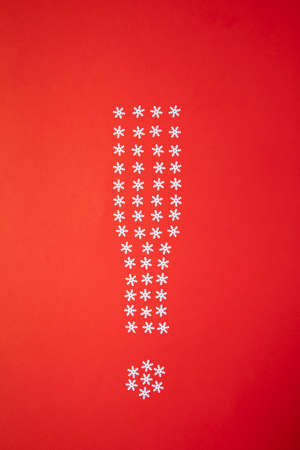 exclamation mark made of snowflakes on red background.Christmas and New Year idea.の写真素材