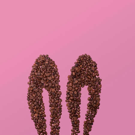 rabbit ears made of coffee beans. Pink background. Easter idea.の写真素材