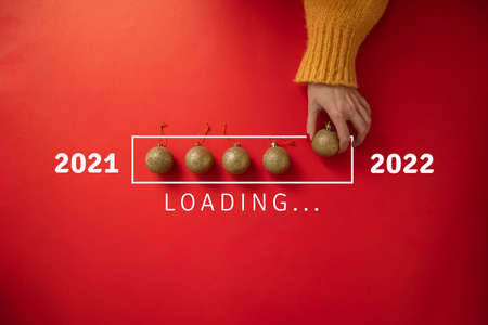 New year loading. 2022 is coming. Gold Christmas decorations on loading scale. from 2021 to 2022.の写真素材