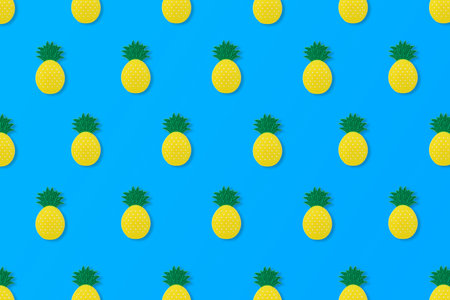 a pattern made of pineapple on a blue background. Cool, summer idea.