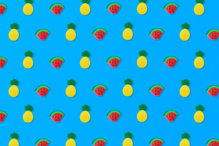 Pattern made of slices of watermelon and pineapple on a blue background. Cool, summer idea.