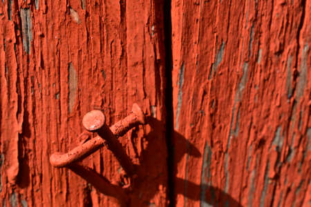 bent nails in old, painted boardsの写真素材