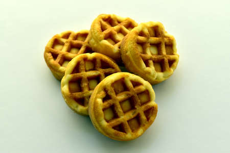 heap of round small waffles on tableの写真素材