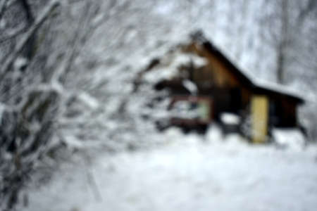 blurred photo of a wooden house in winterの写真素材