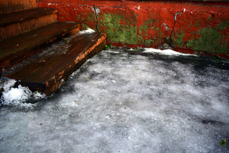 a crust of melting ice by the porchの写真素材