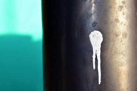 a spot of white paint on a pipeの写真素材