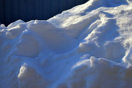 a snowdrift in the morning sunの写真素材