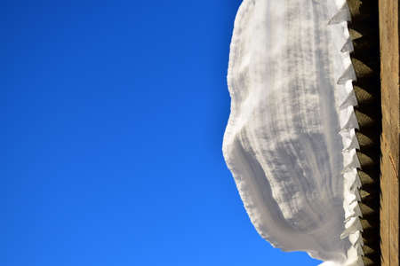 snowdrift on the roof against the skyの写真素材