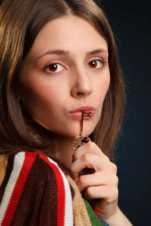 Woman portrait with golden key over lipsの写真素材