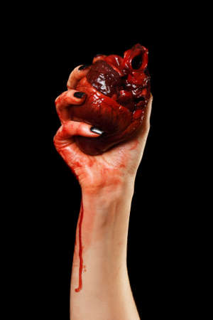 Human heart in hand isolated on black Human heart in hand isolated on black
