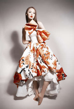 young beautiful asian brunette in gorgeous dressの写真素材