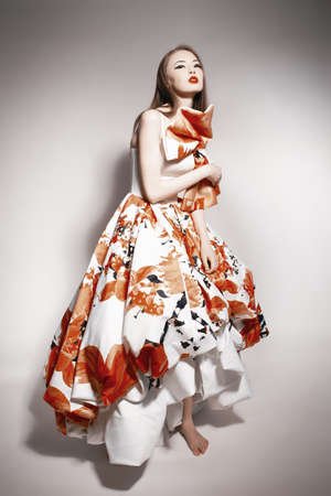 young beautiful asian brunette in gorgeous dress, posingの写真素材