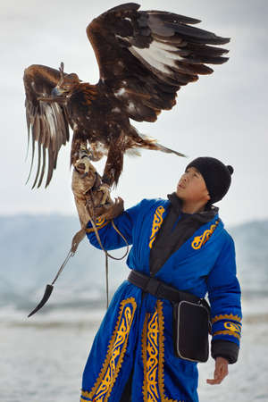 Bird hunter with a golden eagle (Aquila chrysaetos). Kazakhstan.のeditorial素材