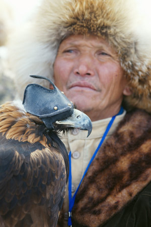NURA, KAZAKHSTAN - FEBRUARY 23: Eagle on man's hand in Nura near Almaty on February 23, 2013 in...