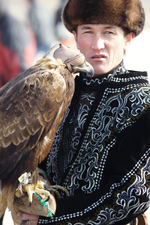 NURA, KAZAKHSTAN - FEBRUARY 23: Eagle on man's hand in Nura near Almaty on February 23, 2013 in...