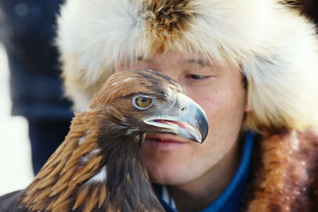 NURA, KAZAKHSTAN - FEBRUARY 23: Eagle on man's hand in Nura near Almaty on February 23, 2013 in Nura, Kazakhstan. The traditional event happens yearly and the place becomes as a medieval times city.のeditorial素材