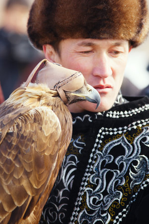NURA, KAZAKHSTAN - FEBRUARY 23: Eagle on man's hand in Nura near Almaty on February 23, 2013 in...