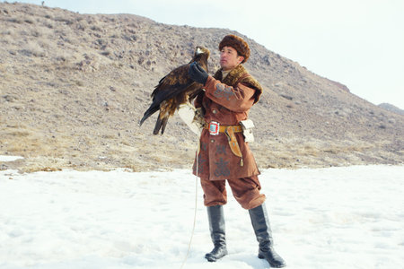 NURA, KAZAKHSTAN - FEBRUARY 23: Eagle on man's hand in Nura near Almaty on February 23, 2013 in...
