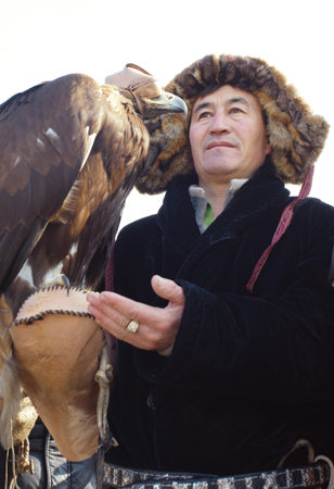 NURA, KAZAKHSTAN - FEBRUARY 23: Eagle on man's hand in Nura near Almaty on February 23, 2013 in...