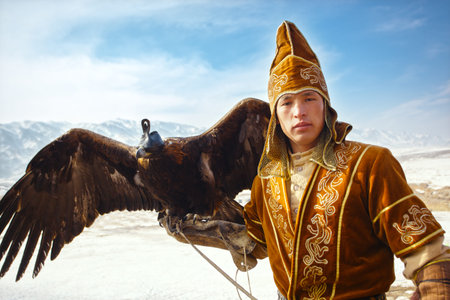 NURA, KAZAKHSTAN - FEBRUARY 23: Eagle on man's hand in Nura near Almaty on February 23, 2013 in...