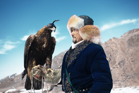 NURA, KAZAKHSTAN - FEBRUARY 23: Eagle on man's hand in Nura near Almaty on February 23, 2013 in...