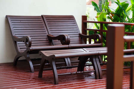 Adirondack wooden chairs on a patio in the garden.の写真素材