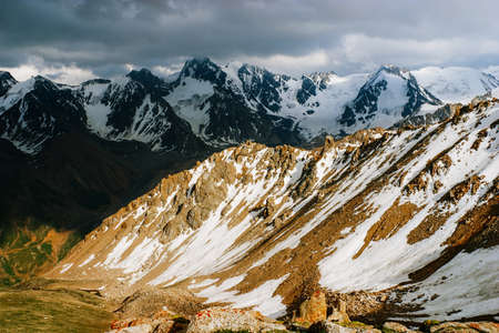 Beautiful Tien shan peaks and mountains near Almaty. Dramatic overcast sky. Beauty world.の写真素材