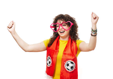 Football or soccer woman fan screaming with supporter attributes isolated on whiteの写真素材