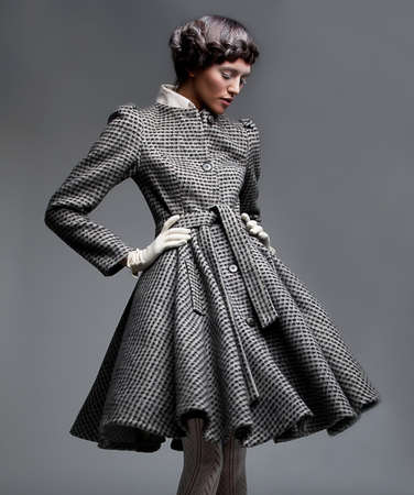 	Fashion model beautiful girl in retro apparel - grey coatの写真素材