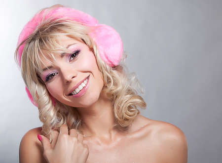 Beautiful bare blonde in pink headphones smiling - series photosの写真素材