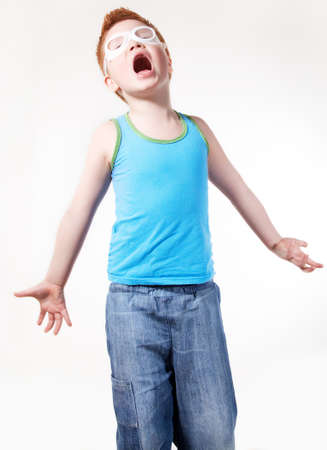 Red hair screaming concerned young boy isolated over white backgroundの写真素材